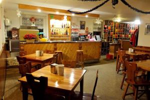 a restaurant with wooden tables and a bar at Le Fontanacce b&b in Vezza dʼOglio