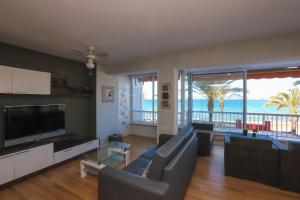 Sala de estar con sofá y TV y el océano en DIFFERENTFLATS Altair, en Salou
