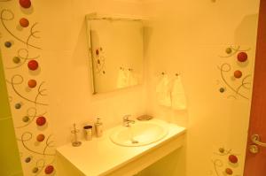 a bathroom with a sink and a mirror at Rado Apartments in Sapareva Banya