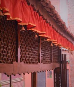 a row of red umbrellas on a building at Inn Sangrahalaya in Bhaktapur