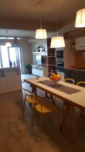 a kitchen with a table with a bowl of fruit on it at Anteo holiday house in Riposto