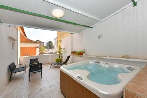 a large bath tub in the middle of a room at Old Town Jacuzzi Suite in Zadar