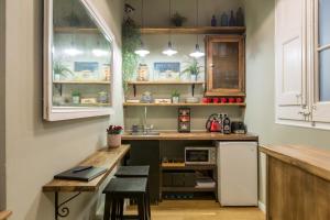 a kitchen with a counter and a sink in it at El Born Guest House by Casa Consell in Barcelona
