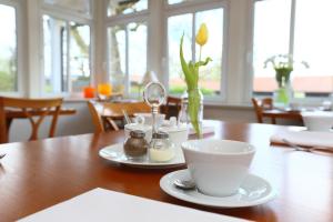 a wooden table with a cup of coffee on it at STADE LAND GOLF HOTEL Tiny Häuser in Deinste