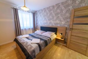 Posteľ alebo postele v izbe v ubytovaní Apartamenty Rodzinne Zdrojowe