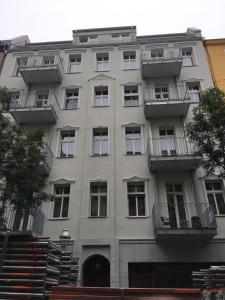 柏林的住宿－Magnificent turn of century flat (legal)，一座高大的灰色建筑,设有窗户和阳台