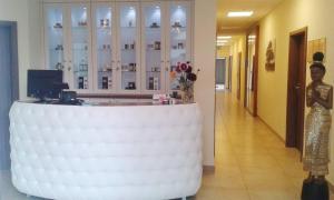 a large white table in a lobby with a vase of flowers at Reha Vital in Stare Siołkowice