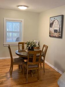 a dining room with a table and chairs and a window at The Countrypolitan in Lewisburg