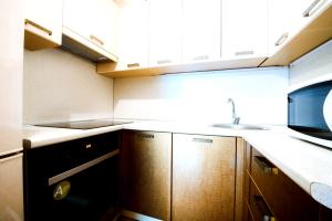 ウファにあるГоголя,79 Двухкомнатные апартаментыの小さなキッチン(木製キャビネット、シンク付)