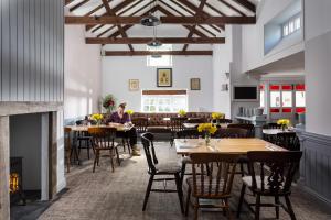 a woman sitting at a table in a restaurant at Rashleigh Arms in St Austell