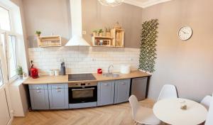 a small kitchen with a sink and a table at Maniu 31 Apartments & Rooms in Oradea