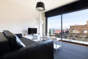 a living room with a couch and a large window at AB Park Güell-Gaudi in Barcelona