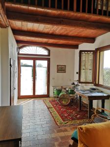 a living room with a wooden ceiling and a table at Agriturismo Elianto in Ravenna
