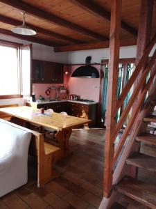a kitchen with a wooden table in a room at Agriturismo Elianto in Ravenna