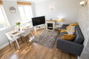a living room with a couch and a table at Ideal Lodgings in Bury - Fairfield in Bury