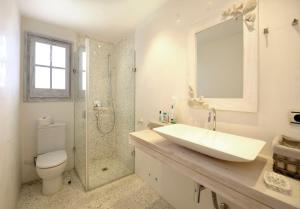 a bathroom with a sink and a shower and a toilet at Casa blanca de Begur con vistas al mar y piscina in Begur +31 photos
