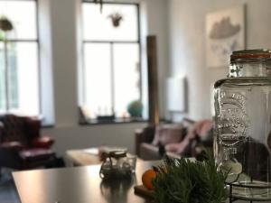a glass jar sitting on a table in a living room at De Pastorie in Middelburg