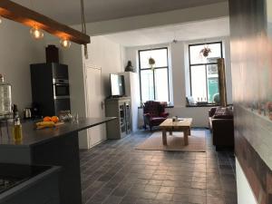 a kitchen and living room with a table in a room at De Pastorie in Middelburg +23 photos