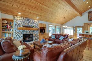 a living room with leather furniture and a stone fireplace at 14 Goldfinch in Sunriver