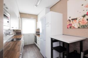 a kitchen with white cabinets and a counter top at Downtown apartment in San Sebastián