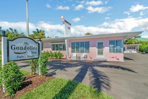 a pink building with a sign in front of it at The Gondolier Inn in Naples