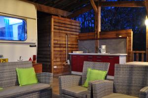 an rv kitchen with chairs and a kitchen with a counter at Camping du Moulin de Thoard in Thoard