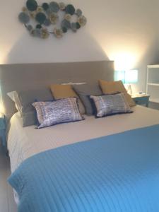 a bed with blue sheets and pillows on it at Trame - Poesia Di Mare in Polignano a Mare