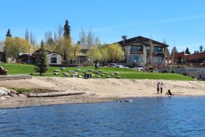 a man standing on a beach next to the water at Aspen Village Condo #32 in McCall