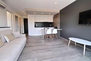 a living room with a couch and a table at Residence ACQUA LINDA Porticcio in Porticcio