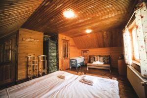 a bedroom with a large bed in a wooden room at Karpatski Polonyny in Urych