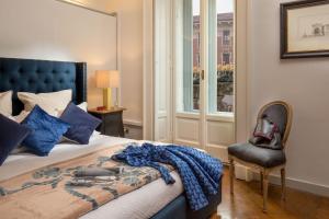A bed or beds in a room at Daplace - Renzo Apartment
