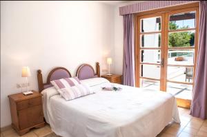 Łóżko lub łóżka w pokoju w obiekcie Apartamento Porto Cari 21
