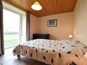 a bedroom with a bed and a large window at Comfortable Cottage in Neufmoulin with Meadow View in Houffalize