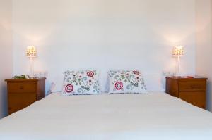 Łóżko lub łóżka w pokoju w obiekcie Apartamento Porto Cari 21