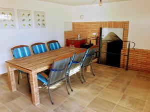 a dining room with a table and chairs and a fireplace at Apartmán Pavlenka in Hustopeče