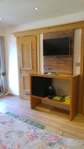 a living room with a flat screen tv on a entertainment center at Haus Mattersberger in Matrei in Osttirol