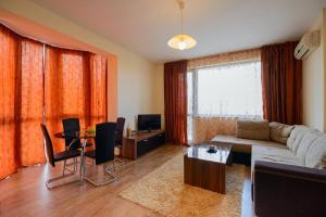 a living room with a couch and a table at Purple Star Apartments in Saints Constantine and Helena