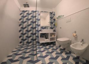 a bathroom with a shower and a toilet and a sink at Sorrento Flats in Sorrento