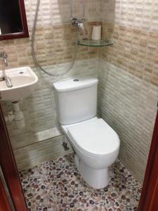 a bathroom with a toilet and a sink at CANADIAN Hostel in Hong Kong