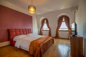 a bedroom with a large bed and two windows at Purple Star Apartments in Saints Constantine and Helena +11 photos