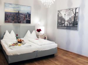 a bedroom with a bed with a plate of food on it at Stadthotel Restaurant Auerhahn in Vöcklabruck
