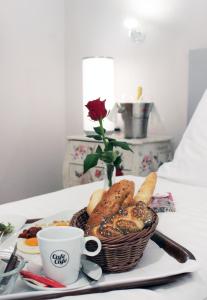 a basket of bread and a cup of coffee on a table at Stadthotel Restaurant Auerhahn in Vöcklabruck