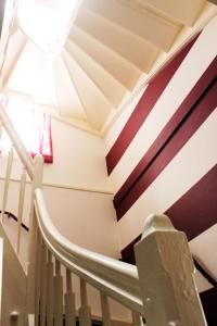 a staircase in a house with a striped ceiling at Stadthotel Restaurant Auerhahn in Vöcklabruck