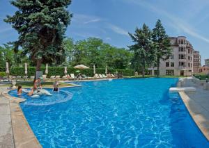 a large swimming pool with people in the water at Purple Star Apartments in St. St. Constantine and Helena