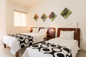 Postel nebo postele na pokoji v ubytování Hotel Catama Inn