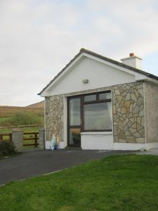 a small house with a large window on it at Sea View Chalet Kilsallagh Westport Co Mayo in Kilsallagh