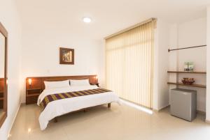 Postel nebo postele na pokoji v ubytování Hotel Catama Inn