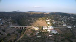 an aerial view of a small town with a bridge at Theofilos Appartements in Livadi +37 photos
