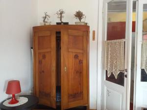 a wooden cabinet in a room next to a door at Apartment Majda in Lendava