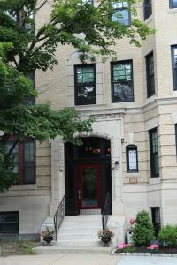 a building with a red door and a tree at A Stylish Stay w/ a Queen Bed, Heated Floors.. #17 in Brookline +6 photos